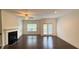 Spacious living room featuring a fireplace, large window, and access to outdoor patio at 32 S Auburn Landing Pl, Auburn, GA 30011