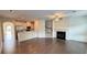 Open concept living room and kitchen featuring hardwood floors and modern amenities at 32 S Auburn Landing Pl, Auburn, GA 30011