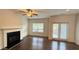 Bright living room featuring a fireplace, hardwood floors and view of the backyard at 32 S Auburn Landing Pl, Auburn, GA 30011