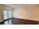 A well lit living room with hardwood floors and double doors to the backyard at 32 S Auburn Landing Pl, Auburn, GA 30011