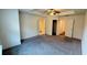 Spacious carpeted main bedroom showcasing multiple entryways and ample natural light at 32 S Auburn Landing Pl, Auburn, GA 30011