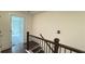 View of staircase with wood and metal railings and hardwood flooring leading to bedrooms at 32 S Auburn Landing Pl, Auburn, GA 30011
