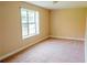 Bright bedroom with a large window providing natural light with carpeted floor at 4527 Berline Dr, Lithonia, GA 30038