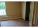Bedroom with carpet, large closet, and ample natural light from a window at 4527 Berline Dr, Lithonia, GA 30038