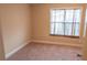 Bedroom with neutral walls and carpeting, offering a bright space with natural light at 4527 Berline Dr, Lithonia, GA 30038