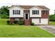 Charming two-story home with a well-manicured lawn, brick facade, and attached two-car garage at 4527 Berline Dr, Lithonia, GA 30038
