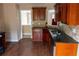 Well-appointed kitchen showcasing wood cabinets, tiled backsplash, and wood-look flooring at 4527 Berline Dr, Lithonia, GA 30038