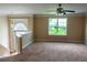 Bright living room featuring plush carpeting, ample natural light, and neutral paint colors at 4527 Berline Dr, Lithonia, GA 30038