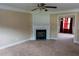 Inviting living room boasts a fireplace, neutral tones, plush carpeting and natural light at 4527 Berline Dr, Lithonia, GA 30038