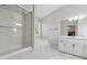 Bright bathroom with a glass shower, soaking tub, white cabinets, and tile flooring at 4147 Pinehurst Valley Dr, Decatur, GA 30034