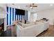 Cozy living room featuring hardwood floors, fireplace, blue striped accent wall, and a ceiling fan at 4147 Pinehurst Valley Dr, Decatur, GA 30034