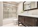 Bathroom with glass enclosed shower/tub, dark wood vanity, and modern vessel sink at 587 Virginia Ne Ave # 609, Atlanta, GA 30306