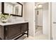 Bathroom featuring tiled walls, dark wood vanity with a modern vessel sink, and updated fixtures at 587 Virginia Ne Ave # 609, Atlanta, GA 30306
