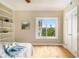 Bright bedroom features hardwood floors, custom shelving and a window overlooking the city skyline at 587 Virginia Ne Ave # 609, Atlanta, GA 30306