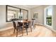 Bright dining area with hardwood floors and natural light reflecting in a large mirror at 587 Virginia Ne Ave # 609, Atlanta, GA 30306