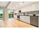 Modern kitchen with white cabinets, stainless steel appliances, granite counters, and hardwood floors at 587 Virginia Ne Ave # 609, Atlanta, GA 30306