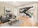 Bright living room featuring hardwood floors, modern decor, and an industrial staircase at 587 Virginia Ne Ave # 609, Atlanta, GA 30306