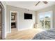 Bedroom with an ensuite bathroom, flat screen television, and sliding glass doors to a balcony at 587 Virginia Ne Ave # 609, Atlanta, GA 30306