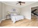 Neutral bedroom with light hardwood floors, a ceiling fan, and two side tables with lamps at 587 Virginia Ne Ave # 609, Atlanta, GA 30306