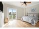Bedroom featuring a ceiling fan, light hardwood floors, and sliding glass doors to a balcony at 587 Virginia Ne Ave # 609, Atlanta, GA 30306