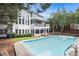 Beautiful backyard showcasing a swimming pool, deck, covered patio, and manicured lawn at 650 Garden Wilde Place, Roswell, GA 30075