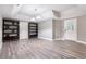 Finished basement area with hardwood floors, open shelving, and a door to the outside at 650 Garden Wilde Place, Roswell, GA 30075