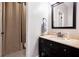 Well-lit bathroom featuring dark vanity with countertop sink and framed mirror at 650 Garden Wilde Place, Roswell, GA 30075