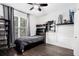 Cozy bedroom with a dark wood floor, nice trim and a large window at 650 Garden Wilde Place, Roswell, GA 30075