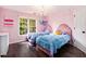Charming pink bedroom with hardwood floors, two twin beds, and a cozy atmosphere at 650 Garden Wilde Place, Roswell, GA 30075