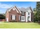 Elegant two-story home with a well-maintained lawn, brick facade, and inviting front entrance at 650 Garden Wilde Place, Roswell, GA 30075