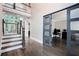 Bright entryway featuring a staircase, hardwood floors, and glass doors leading to an office space at 650 Garden Wilde Place, Roswell, GA 30075