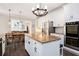 Spacious kitchen with an island, stainless appliances, and adjacent dining area at 650 Garden Wilde Place, Roswell, GA 30075