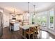 Open kitchen with modern appliances and a dining area with views of the backyard at 650 Garden Wilde Place, Roswell, GA 30075
