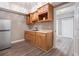 Kitchenette area with wooden cabinets, sink, mini fridge, and views into another room at 650 Garden Wilde Place, Roswell, GA 30075