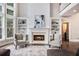 Inviting living room featuring a fireplace, built-in shelving, and large windows at 650 Garden Wilde Place, Roswell, GA 30075