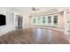 Bright living room with hardwood floors, built-in shelving, and large windows offering plenty of natural light at 650 Garden Wilde Place, Roswell, GA 30075