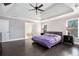Generously sized primary bedroom featuring a trey ceiling, gleaming floors, and an ensuite bathroom at 650 Garden Wilde Place, Roswell, GA 30075