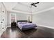 Spacious main bedroom with a trey ceiling, dark hardwood floors, and ample natural light from dual windows at 650 Garden Wilde Place, Roswell, GA 30075