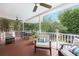 Cozy covered patio featuring comfortable seating and a dining area, perfect for outdoor relaxation and entertaining at 650 Garden Wilde Place, Roswell, GA 30075