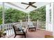 Relaxing outdoor porch features comfortable seating and a view of the lush trees at 650 Garden Wilde Place, Roswell, GA 30075