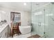 Luxurious bathroom with a freestanding tub and glass-enclosed shower stall at 6628 Londonderry Dr, Morrow, GA 30260