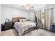 Cozy bedroom with a plush bed, soft carpet, and a bright window view at 6628 Londonderry Dr, Morrow, GA 30260