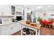 Kitchen with white cabinets, stainless appliances and an adjacent dining area at 6628 Londonderry Dr, Morrow, GA 30260