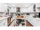 Updated kitchen with white cabinets, stainless steel appliances and kitchen island at 6628 Londonderry Dr, Morrow, GA 30260