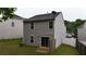 View of backyard with newly installed sliding glass doors and wood privacy fence at 176 Silver Fox Trl, Dallas, GA 30157