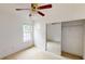 Bedroom with mirrored closet doors, ceiling fan with lighting, and a window at 176 Silver Fox Trl, Dallas, GA 30157