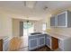 Open concept kitchen with gray cabinets and a view of the sliding glass doors at 176 Silver Fox Trl, Dallas, GA 30157