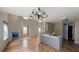 Open kitchen with gray cabinets, hardwood floors, and a view of the living room at 176 Silver Fox Trl, Dallas, GA 30157