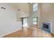 Cozy living room with fireplace, gleaming hardwood floors and ample natural light at 176 Silver Fox Trl, Dallas, GA 30157