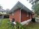 Exterior view of a brick home with a grassy yard and foliage at 301 Sisson Ne Ave, Atlanta, GA 30317